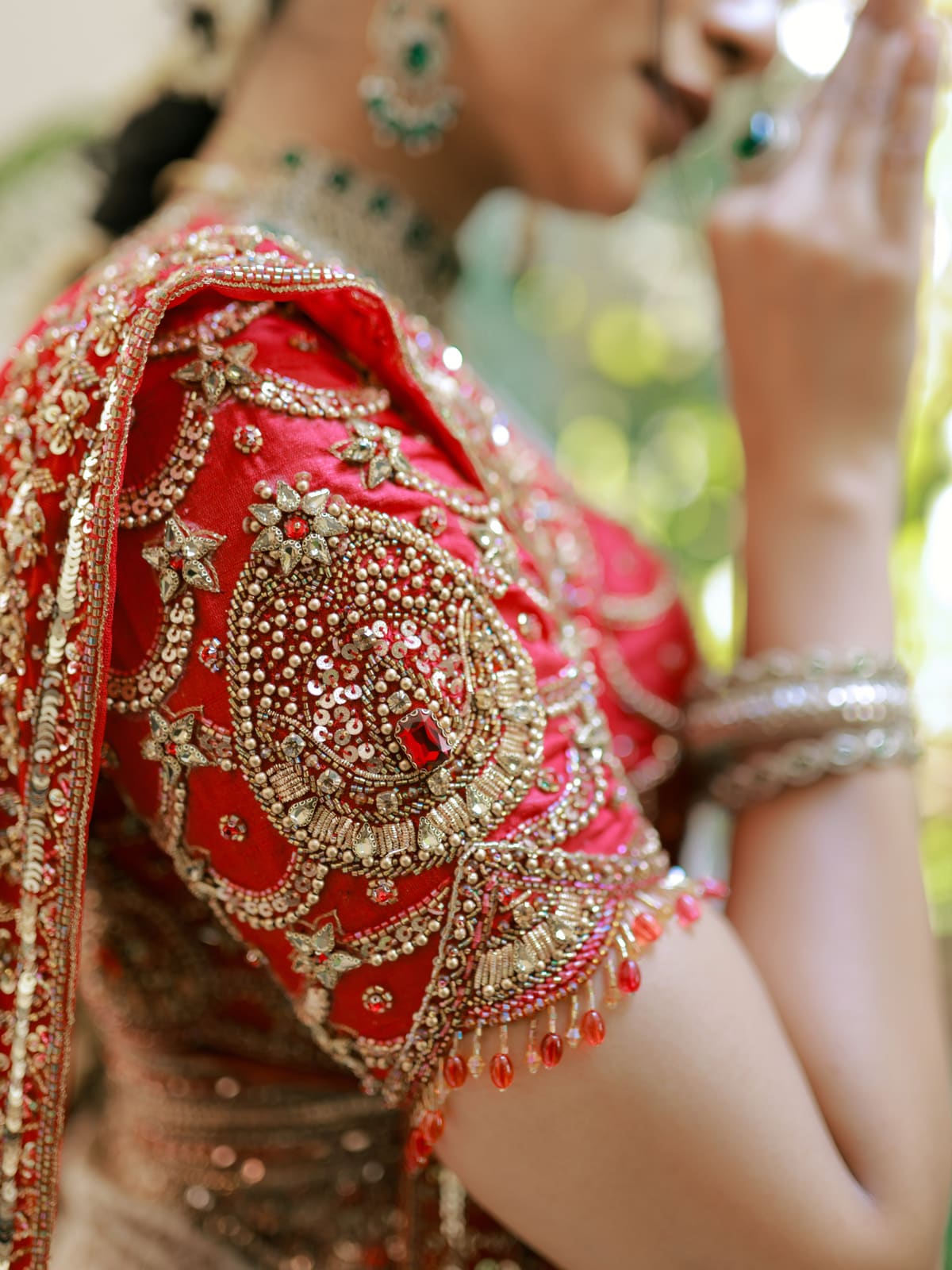 Zardozi medallion hand-embroidered in gold on a red silk sleeve