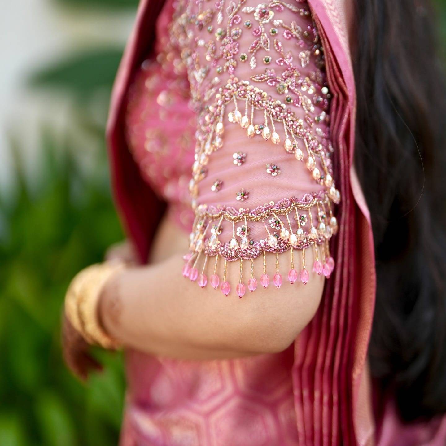 Real bride in a rani-pink silk saree with a hand-embroidered blouse