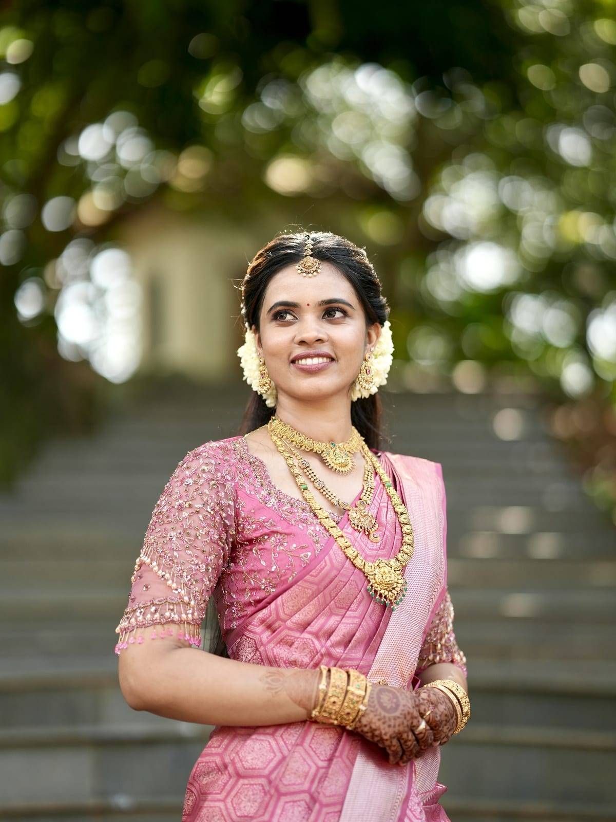Real bride in a rani-pink silk saree with a hand-embroidered blouse